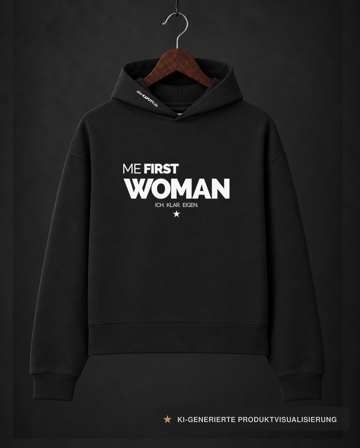 Schwarzer ME FIRST WOMAN Cropped-Hoodie von alle-KAPUTT mit weißem Print und dem Claim „ICH. KLAR. EIGEN.“ am Holzkleiderbügel.